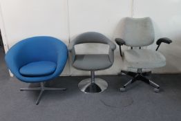 A mid 20th century swivel armchair and two tub chairs