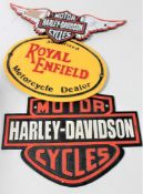 Three cast iron signs : Two Harley Davidson,