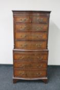 A Victorian style tall boy fitted with eight drawers
