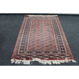 A Bokhara rug on peach ground,