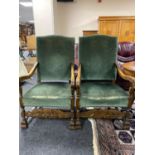 An early twentieth century oak scroll arm chairs upholstered in green dralon