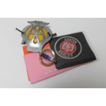 A box containing vintage AA badge, two cloth Austin Healey badges,