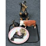 A tray of pottery Hereford bull figure, three further figures of Doberman, wall plaque,
