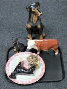 A tray of pottery Hereford bull figure, three further figures of Doberman, wall plaque,