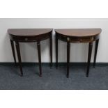 Two mahogany demi-lune tables fitted with a drawer