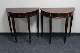 Two mahogany demi-lune tables fitted with a drawer