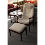 A stained beech armchair and footstool in beige fabric