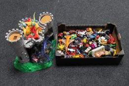 A box of die cast vehicles - Matchbox etc and a toy castle with figures