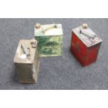 Three petrol cans : Shell, Esso and Pratts,