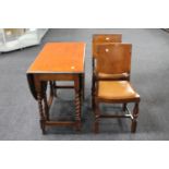 An oak gate leg table and two dining chairs