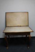 An Edwardian oak card table on pad feet,