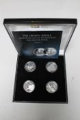 The Crown Jewels Silver Proof Coin Set by The London Mint, four $10 coins set with a diamond, ruby,