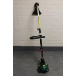 A Qualcast petrol garden strimmer