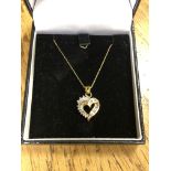 A 10ct gold diamond set heart pendant on chain