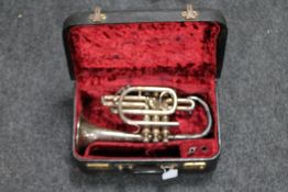 A cased cornet with mouthpiece in case