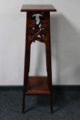 A reproduction carved mahogany plant stand