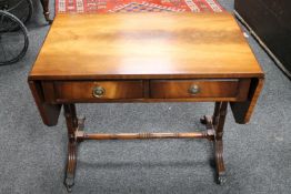 A reproduction low table fitted with two drawers