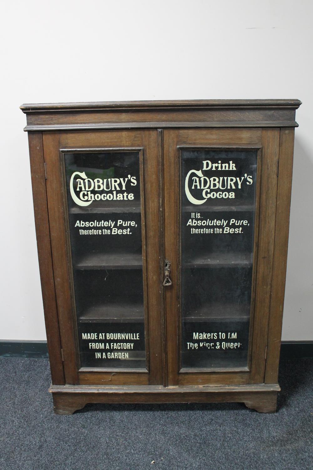 An Edwardian and later bookcase with "Cadbury's" advertising