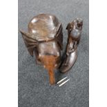 An Eastern hardwood figure of a field worker and a wooden elephant stand