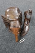 An Eastern hardwood figure of a field worker and a wooden elephant stand