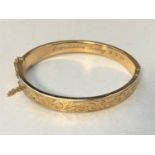 A 9ct gold bangle CONDITION REPORT: 12.3g. Internal measurements 6cm by 5cm.