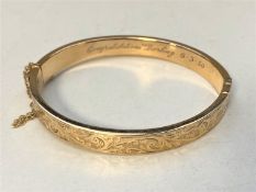 A 9ct gold bangle CONDITION REPORT: 12.3g. Internal measurements 6cm by 5cm.