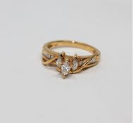 A 14ct gold marquise and baguette-cut diamond ring, size K.
