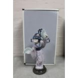 A Lladro figure of a Geisha holding fans