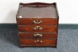 A stained beech wood four drawer storage chest