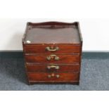 A stained beech wood four drawer storage chest