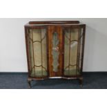 A 1920's walnut display cabinet