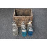 An antique wooden crate of six soda water siphons branded Zephyr and Schweppes