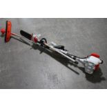 A petrol garden multi tool with attachments including hedge trimmer, chain saw,