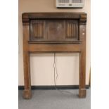 An Edwardian linen fold oak fire surround