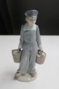 A Lladro figure of a young girl carrying buckets