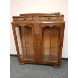 A 1930's carved oak display cabinet, probably Lees,