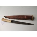An Eastern dagger with bone hilt in leather scabbard CONDITION REPORT: Length 30cm