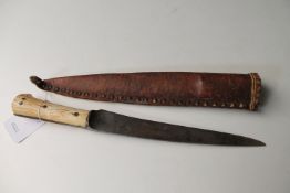 An Eastern dagger with bone hilt in leather scabbard CONDITION REPORT: Length 30cm