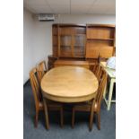 A mid century teak oval dining table and four chairs,