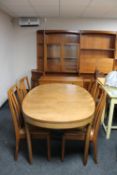 A mid century teak oval dining table and four chairs,