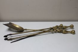 A three piece Victorian brass companion set