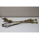 A three piece Victorian brass companion set