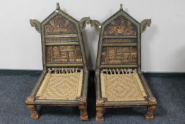 A pair of unusual Eastern low chairs with brass mounts and a matching low table (3)