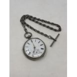 A heavy silver antique pocket watch on silver Albert chain