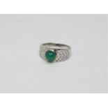 An 18ct white gold cabochon emerald and diamond ring, 6.