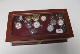 A coin collector's cabinet containing fourteen various modern pocket watches