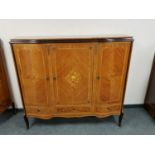 A reproduction bow fronted sideboard cabinet with inlaid panel doors,
