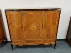 A reproduction bow fronted sideboard cabinet with inlaid panel doors,