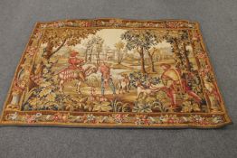 A large tapestry wall hanging depicting figures hunting