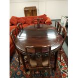 A Chinese hardwood extending dining table and matching set of six chairs.